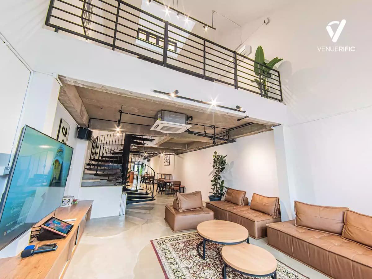 bachelorette party venue with cozy vibes decorated with mid century modern furniture and persian rug and indoor plants