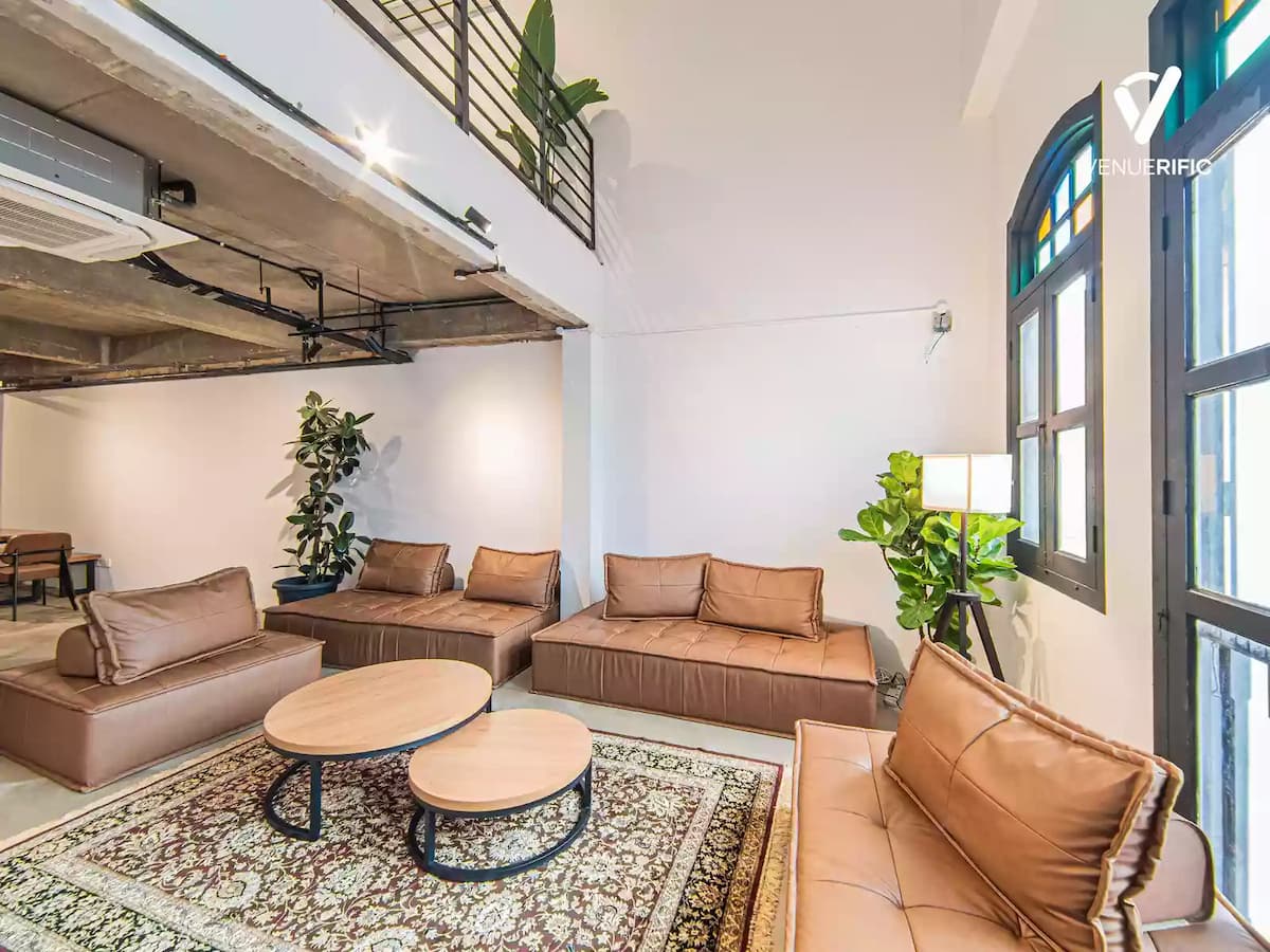 event venue for rent in singapore with vintage leather couches and big glass windows