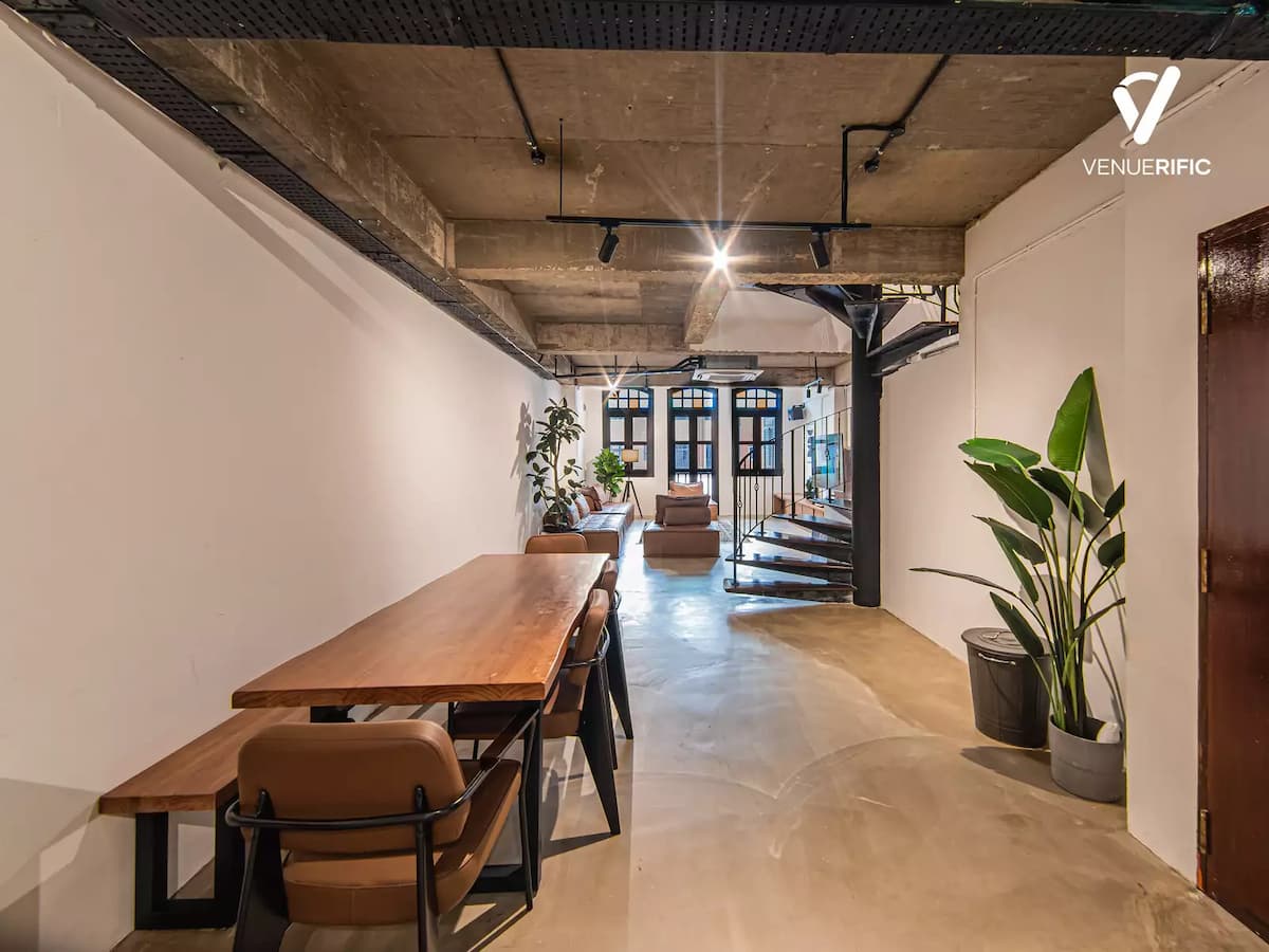 offsite event venue for rent in singapore with wooden table and leather chairs