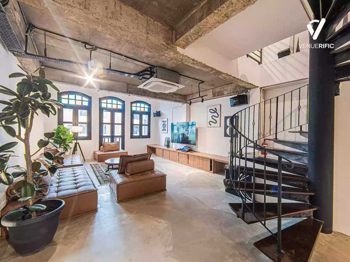 bachelorette party venue with cozy vibes decorated with mid century modern furniture and persian rug and indoor plants